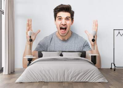 Portrait of smiling man with the fists up isolated a white background Wall mural